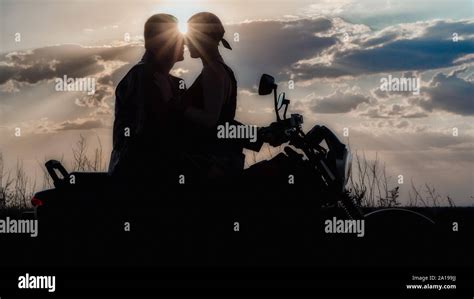 Romantic Silhouette Couple Man And Woman On A Motorcycle On The