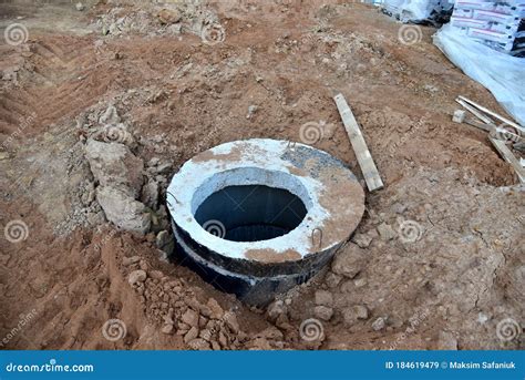 Installation Of Concrete Sewer Wells In The Ground At The Construction