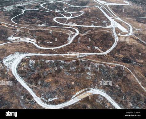 Dirt trail race track road aerial photo in winter with covered in snow ...