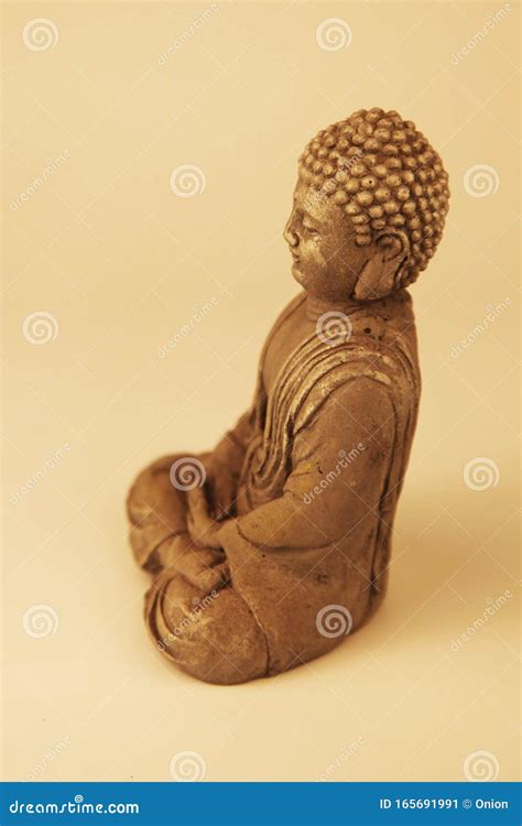 Buddha Statue Sitting Down With Legs Crossed In Prayer Stock Image