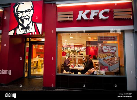 Exterior Night People Eating In A Branch Of Kfc Kentucky Fried