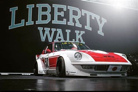 A White And Red Race Car Sitting In Front Of A Sign That Reads Liberty Walk