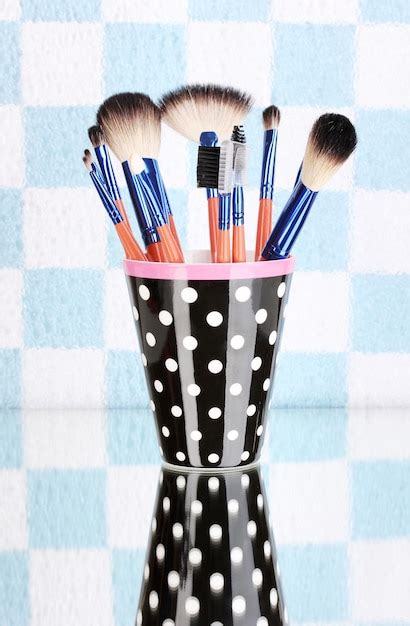 Premium Photo Makeup Brushes In A Black Polkadot Cup On Colorful