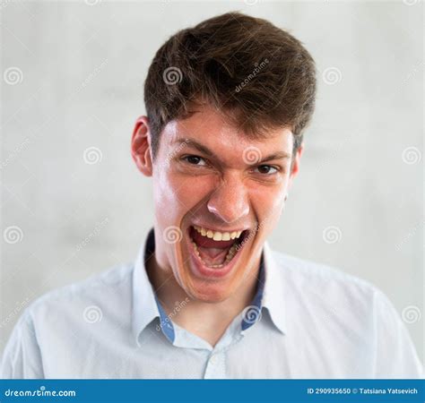 portrait  young screaming guy  studio stock photo image  wall
