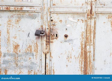 Metal Door With Rust With A Lock Crack And Old Loose White Paint