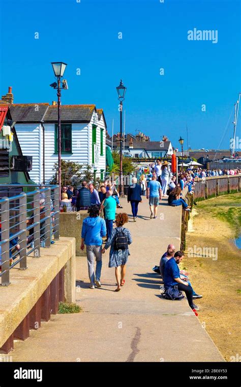 People Walking Along The Coastal Seaside Promenade In The Summer In