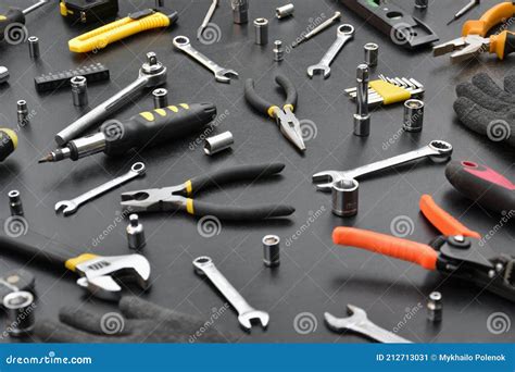 Handyman Tool Kit On Black Wooden Table Many Wrenches And Screwdrivers