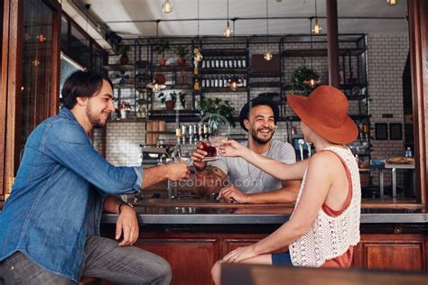 Young Friends At Cafe Toasting Drinks Jacob Lund Photography Store