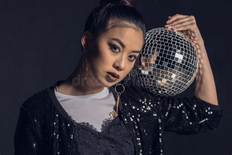 Portrait Of Glamour Asian Girl Posing With Disco Ball And Looking At