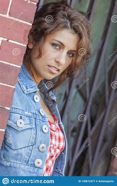 Lovely Ethnic Brunette Model Posing Outdoors In A City Environment