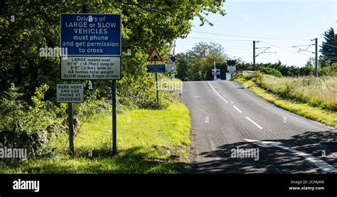 Warning road sign at East Coast mainline railway line level crossing ...