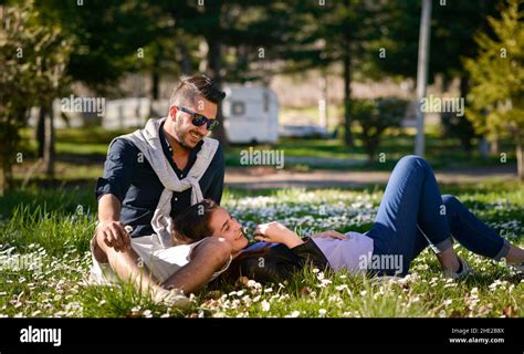 happy couple laying on a grass Stock Photo - Alamy