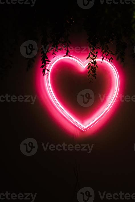 Neon red heart on black wall 15130467 Stock Photo at Vecteezy