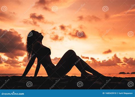 Woman Silhouette Against Sunset On The Beach Stock Photo Image Of