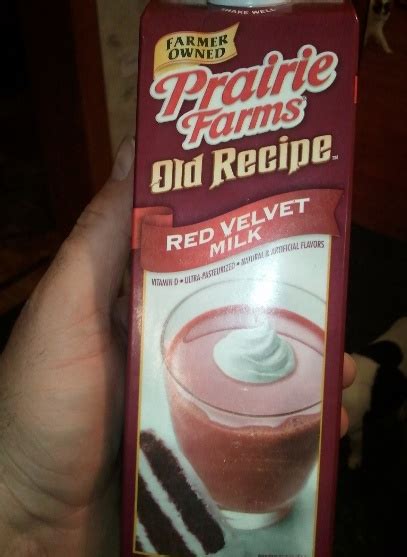 A Person Holding Up A Carton Of Old Recipe Red Velvet Milkshake Drink