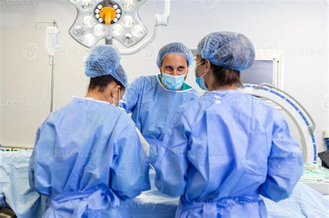 Surgeons performing operation in operation theater. breast augmentation