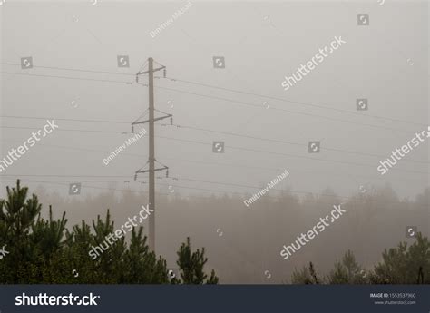 High Voltage Pylon Shrouded Morning Fog Stock Photo