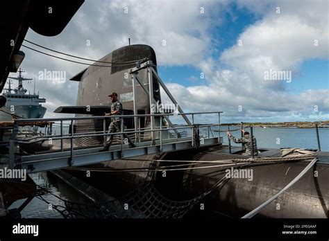 Crew members are seen working onboard HMAS Rankin, a Collins Class ...