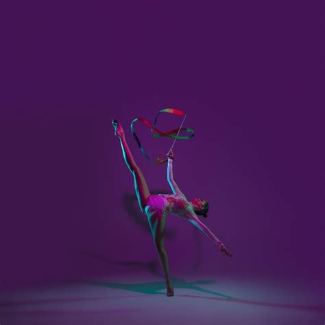 Premium Photo | Vibrant. Young female athlete, rhythmic gymnastics artist dancing, training with ...