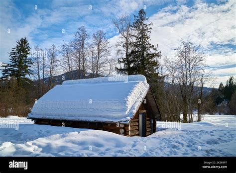 Rustic Log Cabin in Winter. A winter landscape with a rustic snow ...