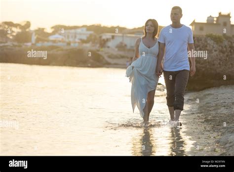 Happy Romantic Middle Aged Couple Enjoying Beautiful Sunset Walk On The