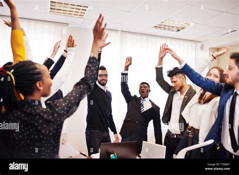 Multiracial Business People Standing At Office And Put Hands Up