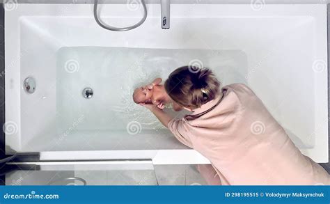 Top View of Mother Bathing Her Newborn Baby, Newborn Baby Care Concept ...