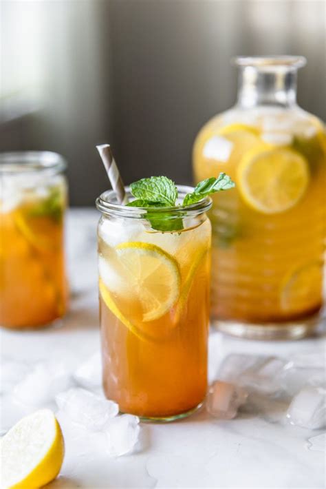 Two Glasses Filled With Iced Tea And Lemon Slices