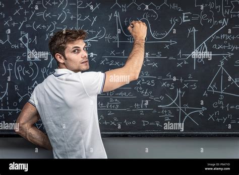 Portrait Of Caucasian Teacher Writing On Chalkboard Stock Photo Alamy