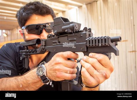 A Man Using Iwi Israel Weapon Industries Firearms In A Show Stock