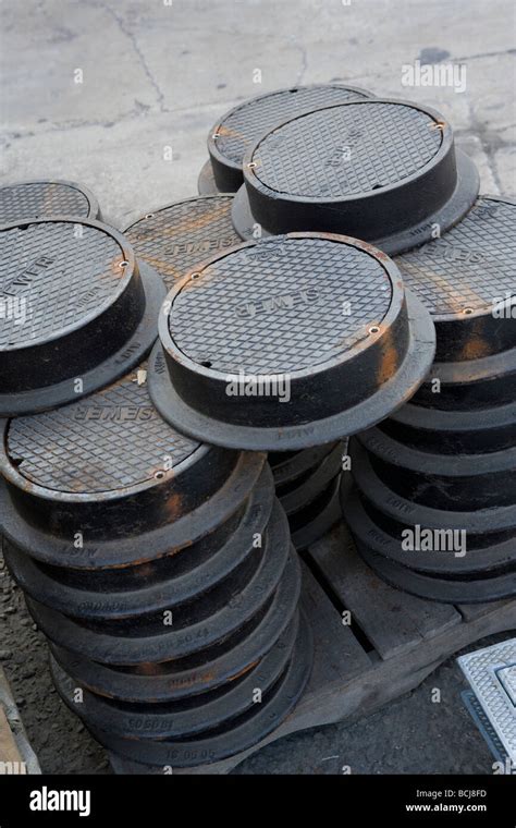 Stack Of Circular Cast Iron Manhole Covers With Sewer Molded Into Top