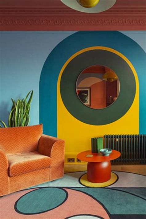 A Living Room Filled With Furniture And Colorful Walls