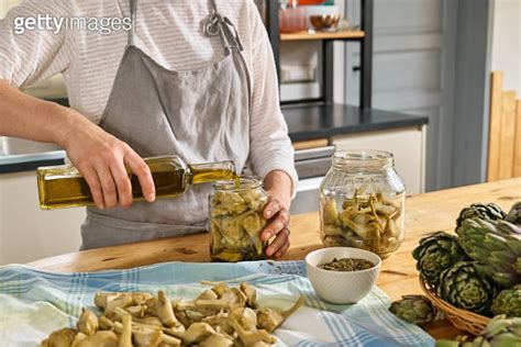 Woman Preparing Canned Italian Artichokes In Olive Oil Artichoke