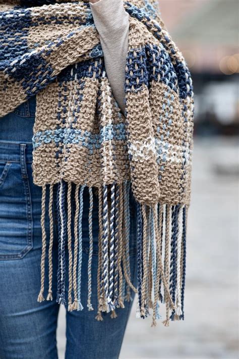 A Woman Is Wearing A Scarf And Jeans