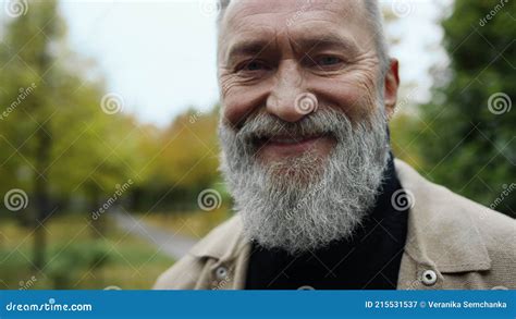 Close Up Portrait Of Bearded Man Looking At Camera Outdoors Happy