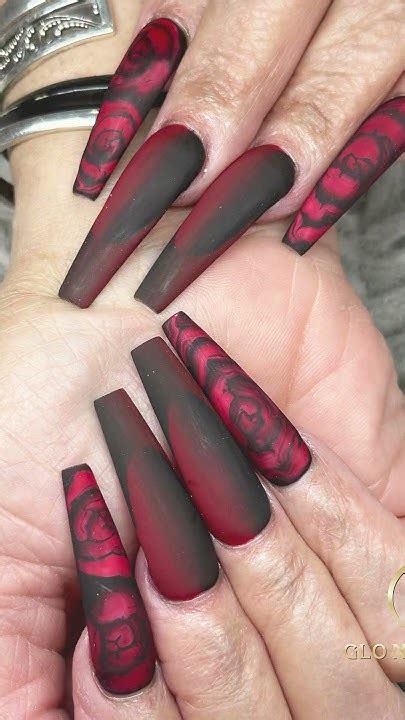 Master the art of stylish black long nails with a striking red accent