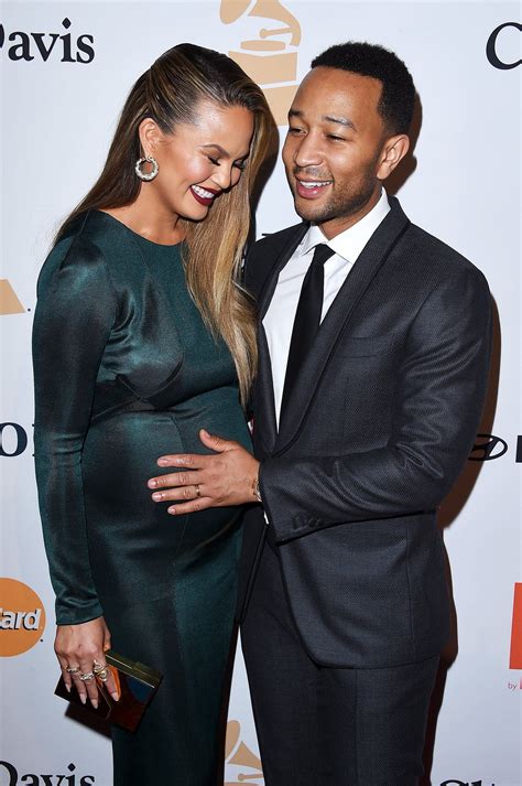 John legend adorably carries baby girl esti in carrier on family trip