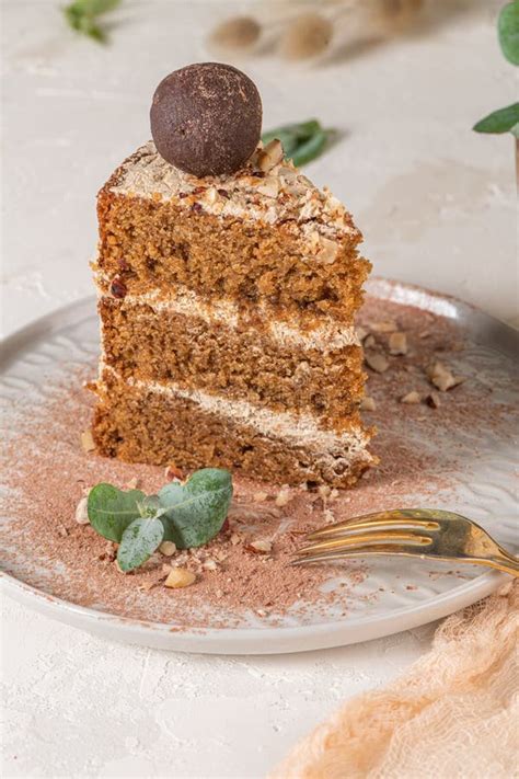 Slice Of Delicious Naked Chocolate And Hazelnuts Cake On Table Rustic Wood Kitchen Countertop