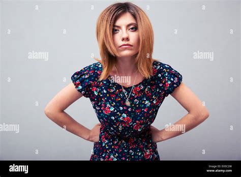 Portrait Of Angry Woman Looking At Camera Over Gray Background Stock