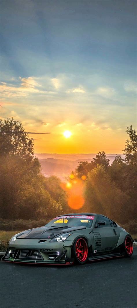 a car driving down the road at sunset