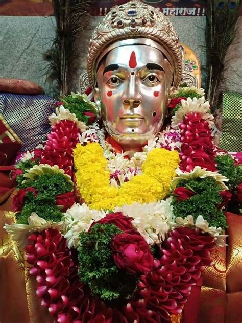 the statue is adorned with flowers and garlands