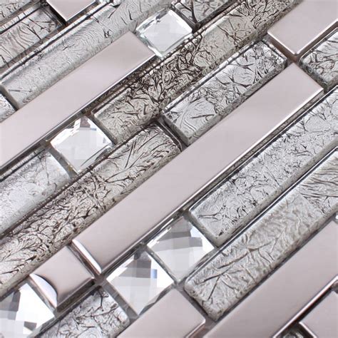 A Close Up View Of Some Glass Tiles On A Wall With Silver Foil And Diamonds