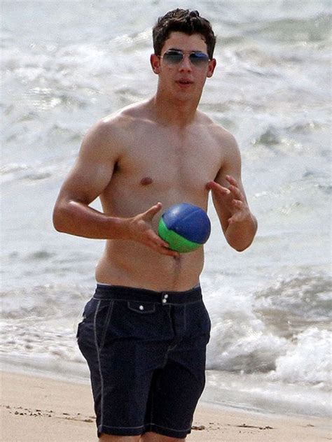 The Men Of Hollywood Nick Jonas Shirtless Holding A Ball At The Beach