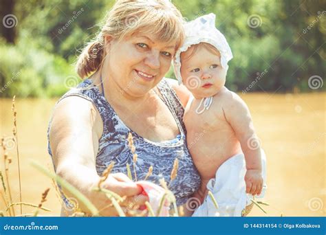 Grandmother With Granddaughter In Her Arms Stock Photo Image Of Care