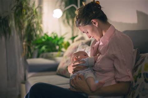 Young Beautiful Mother Breastfeeding Her Newborn Baby Boy At Ni ⬇