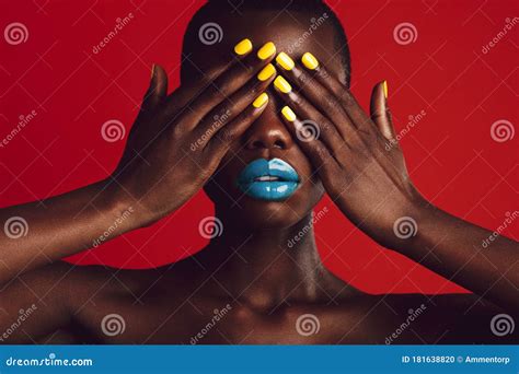 African Woman with Colorful Makeup Covering Her Eyes Stock Photo ...