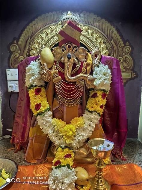 The Statue Of Lord Ganesh Is Surrounded By Flowers