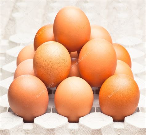 Group Of Dark Chicken Eggs Stacked In Pyramid — Stock Photo © Jultud