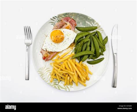 Gammon fried egg chips and peas Stock Photo - Alamy