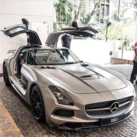 A Mercedes Sls Amg With Its Hood Open And People Looking At The Car